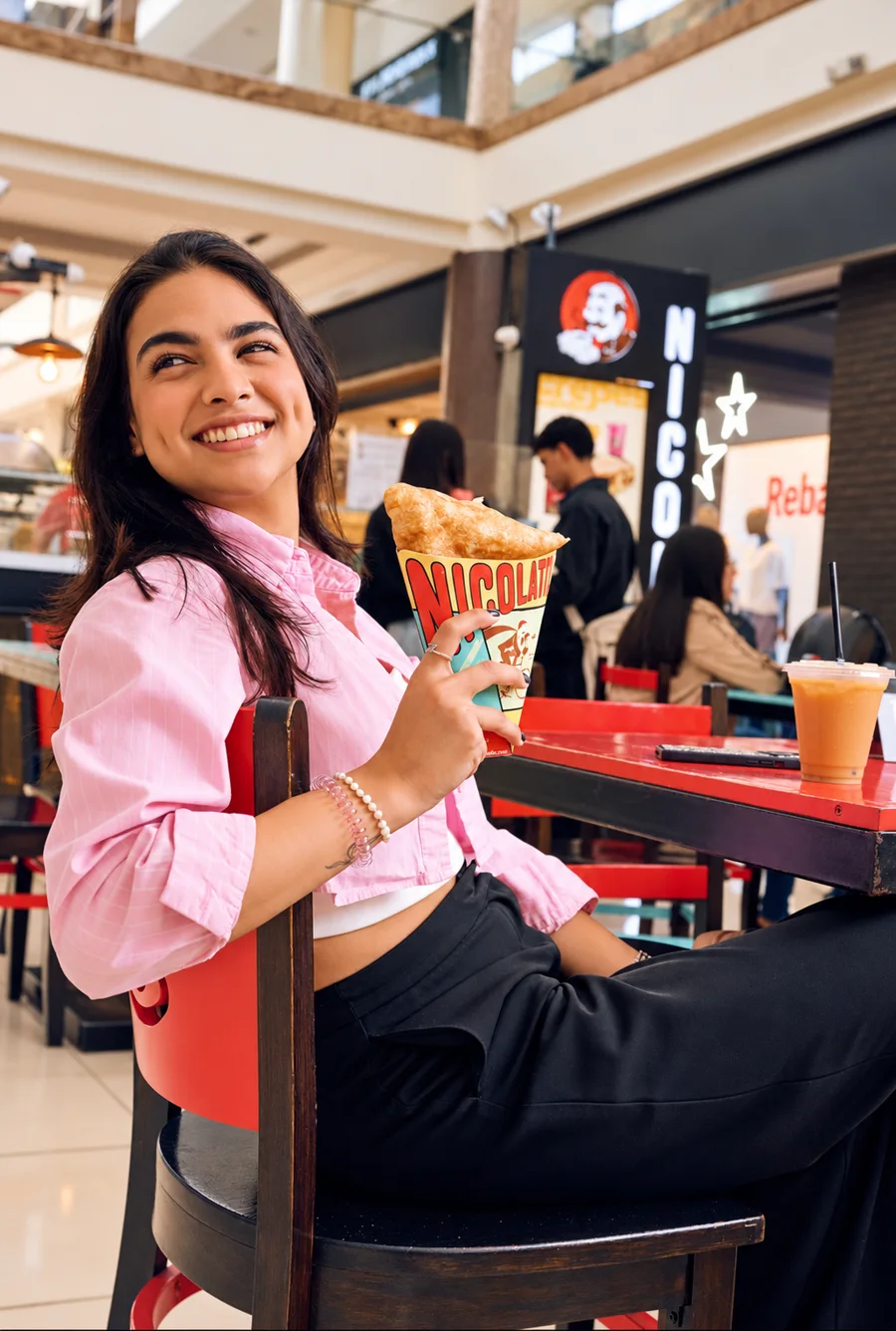 Clienta sonriendo con su crepa NICOLATI'S en el mall
